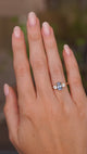Video of a vintage-inspired blue sapphire and diamond three-stone engagement ring worn on the hand.