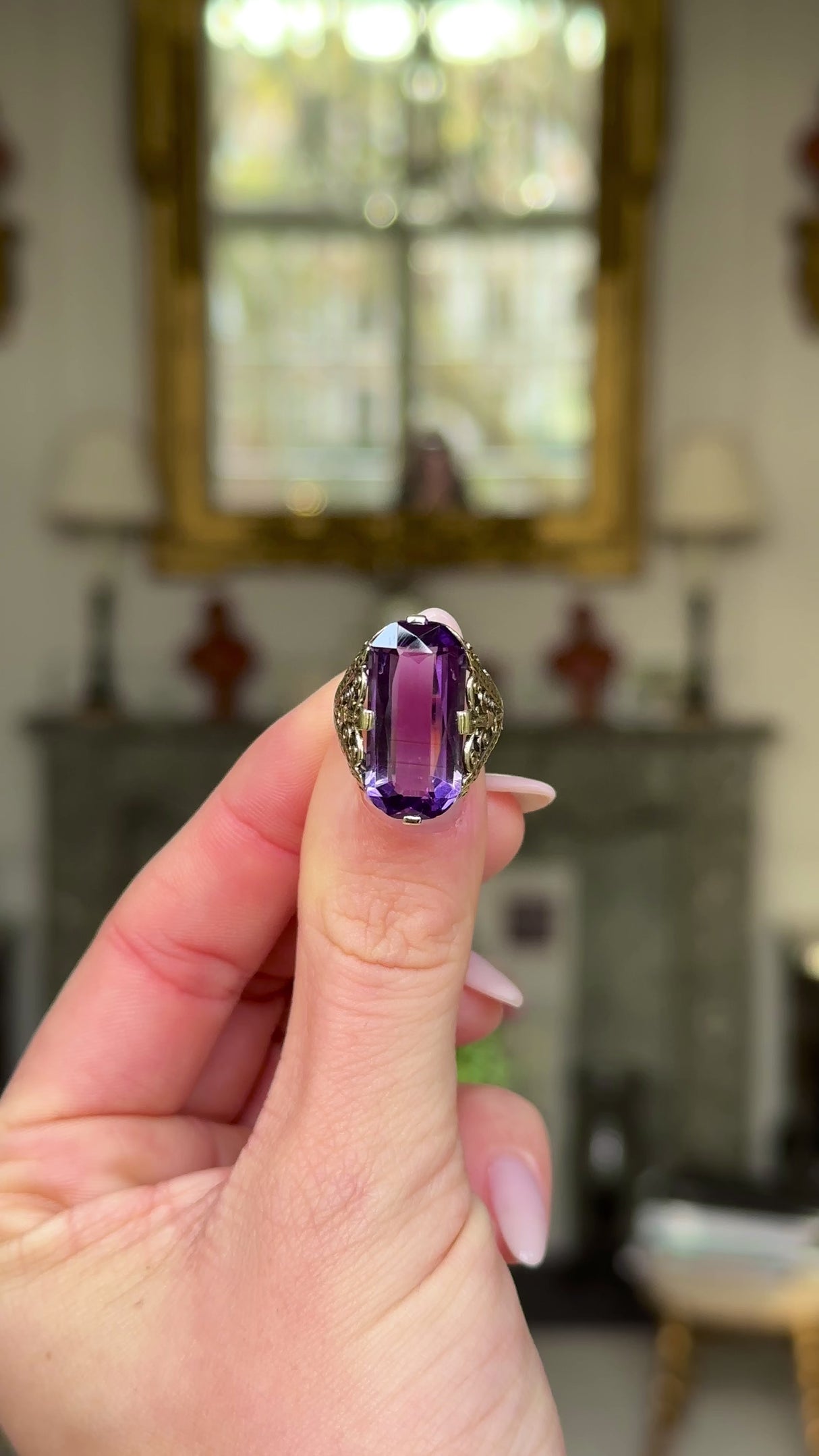 Victorian amethyst and 14ct yellow gold ring held in fingers and moved around to give perspective.