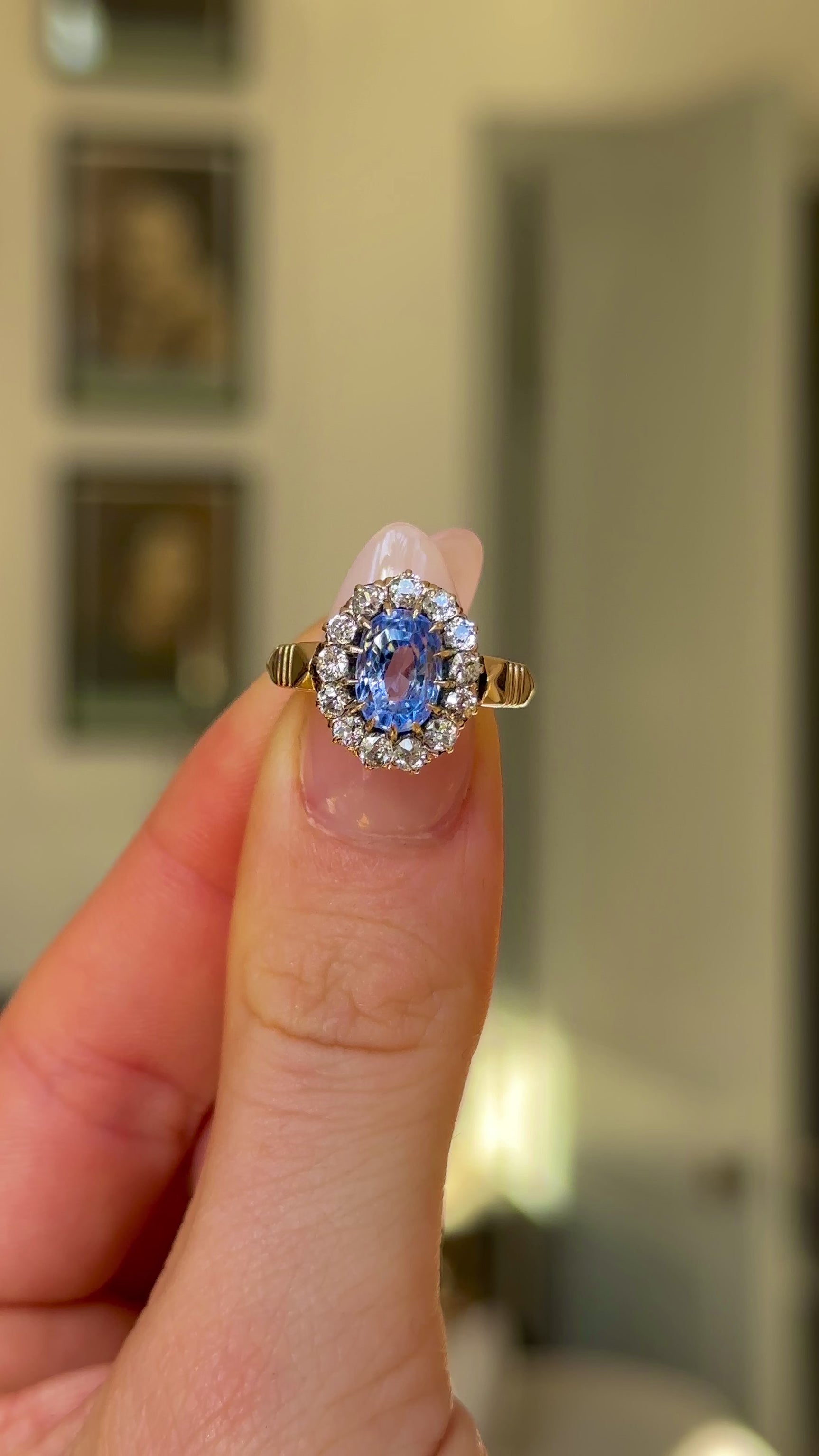 Antique, Edwardian Sapphire and Diamond Cluster Ring, 14ct Yellow Gold held in fingers and rotated to give perspective.