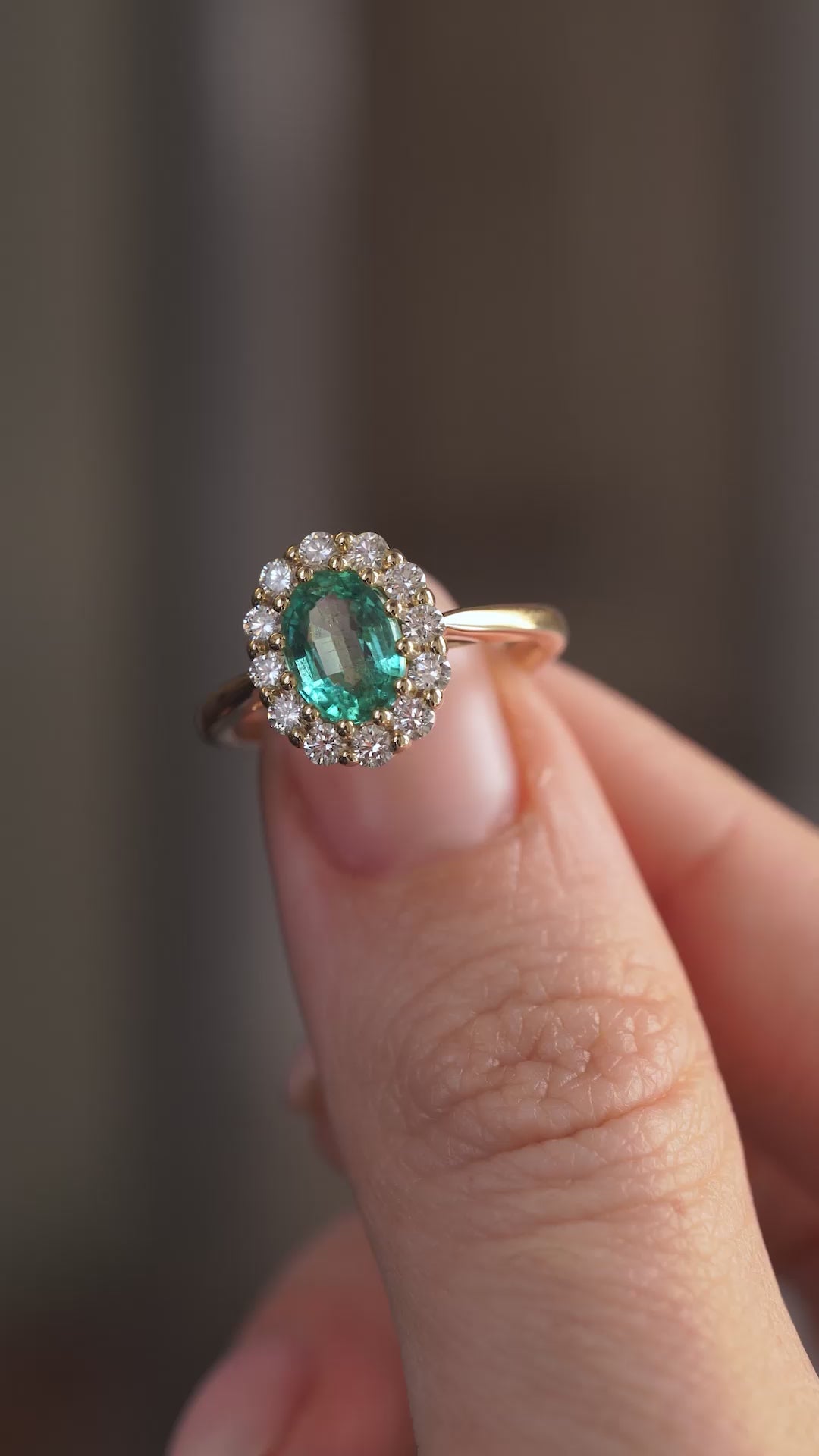 Video showcasing the antique-inspired emerald engagement ring on the hand as the gemstones catch the light.