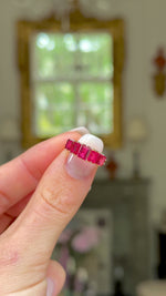 Antique spinel half hoop ring, held in fingers and moved around to give perspective.