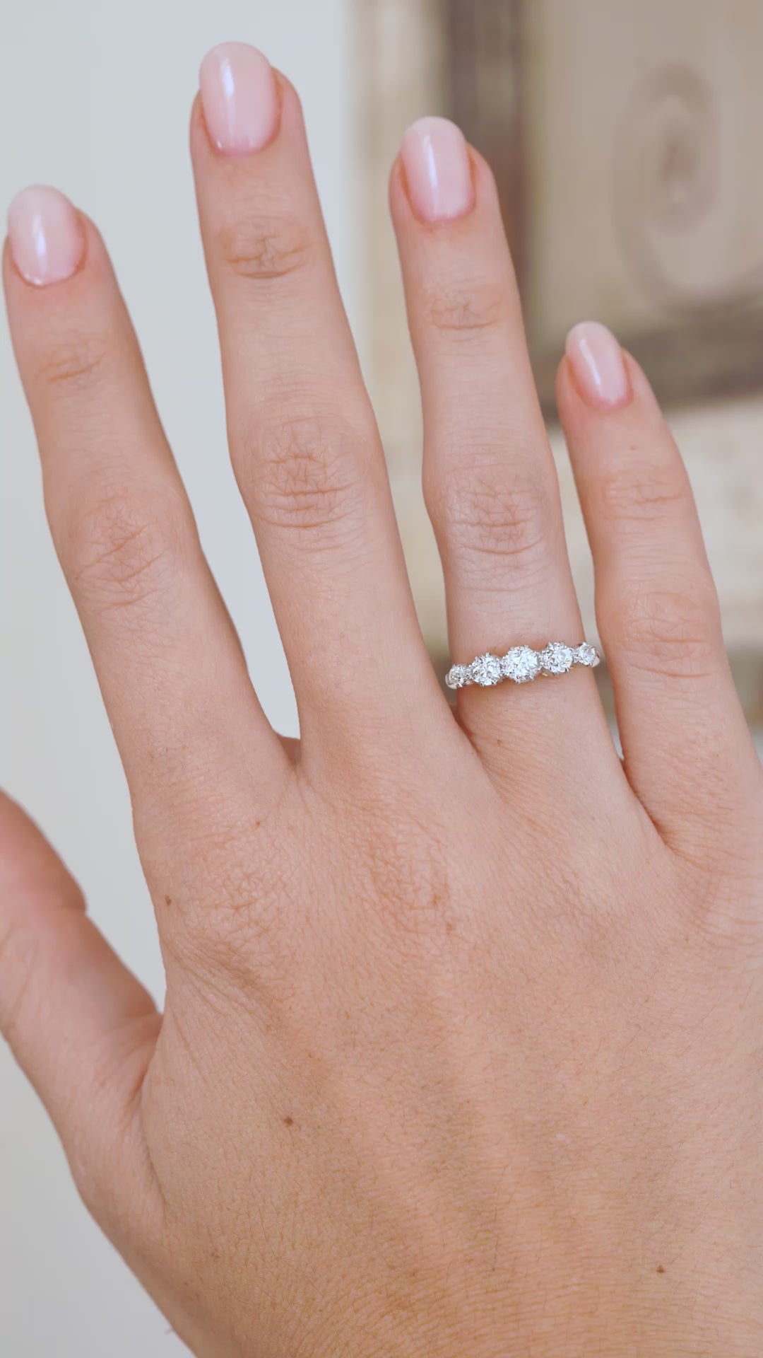 Video of the antique five-stone engagement ring being worn, capturing the lively sparkle of its old-cut diamonds.