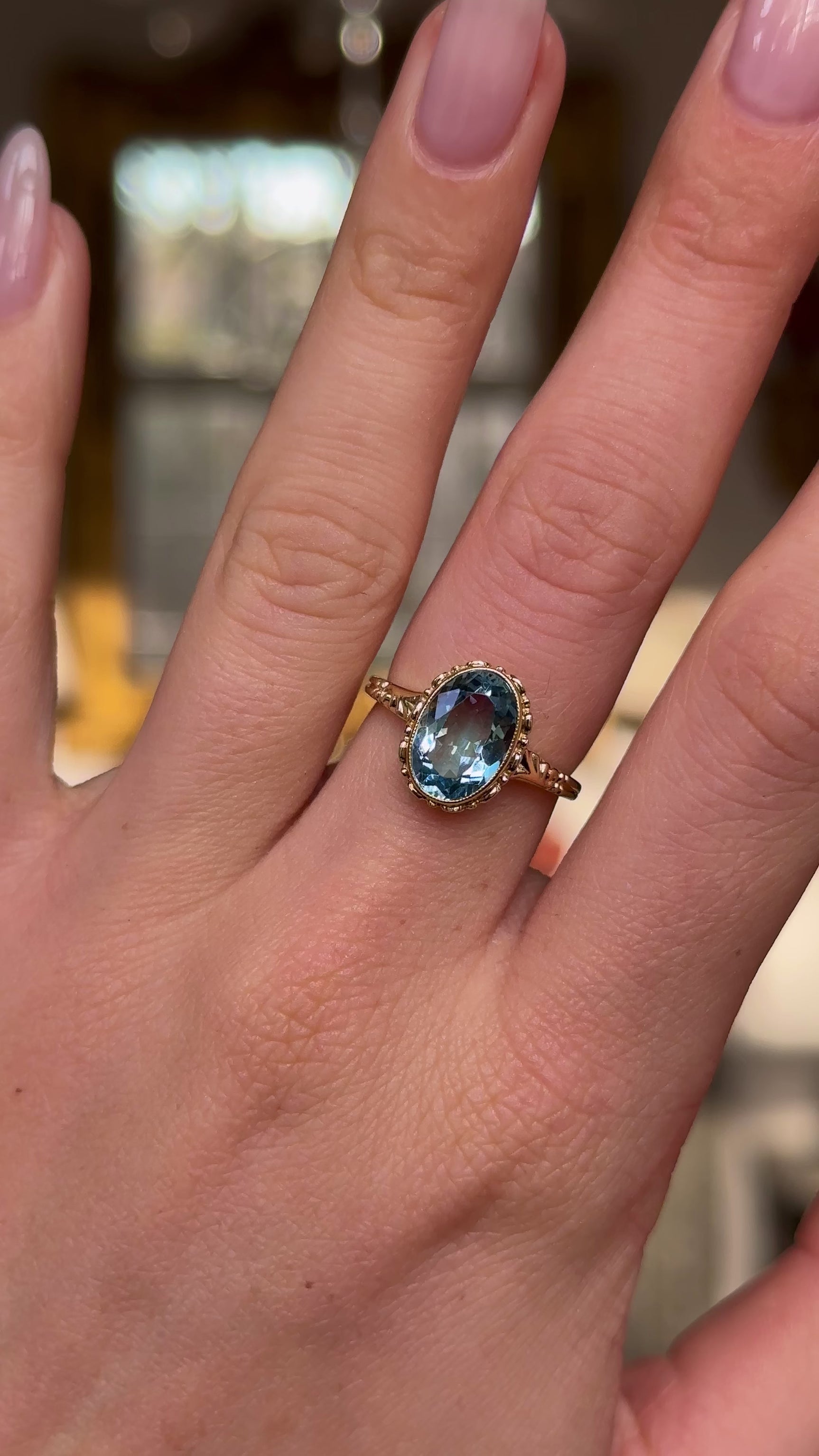 antique oval cut aquamarine singe stone ring worn on hand and moved around to give perspective.