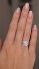 A video of a hand wearing an Antique, Edwardian diamond cluster engagement ring in platinum shown for scale.