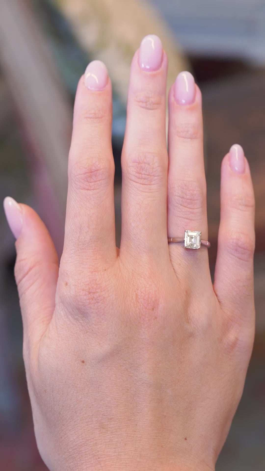 Vintage 1980s solitaire diamond ring worn on hand in motion.