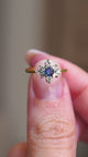 A video of a vintage blue sapphire & diamond cluster arranged as a Maltese-cross set in gold. 
