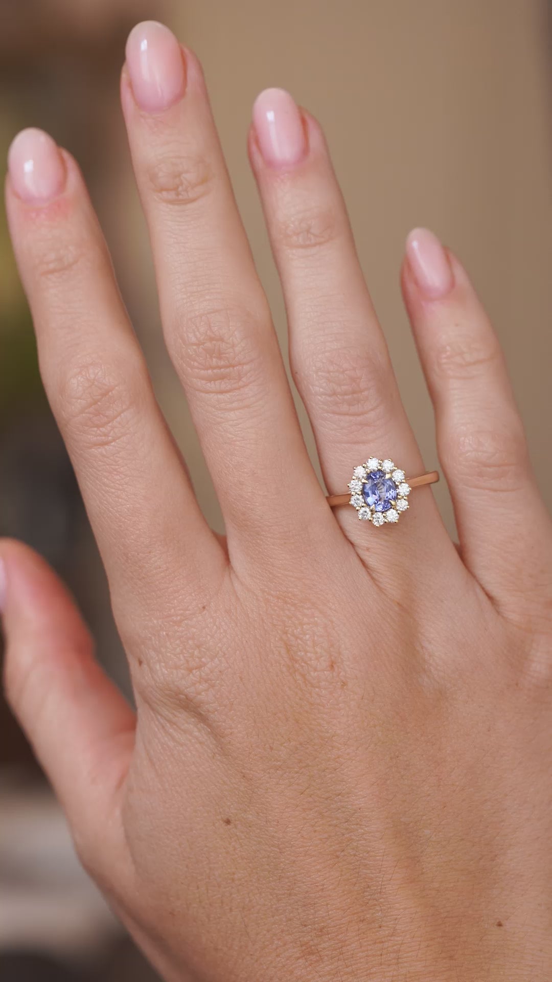 Video showcasing the sapphire and diamond halo ring on the hand as the blue gemstone and surrounding diamonds catch the light.