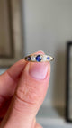  A close up video of an Antique, Victorian sapphire & diamond five-stone gold engagement ring rotated to show all angles of the ring.