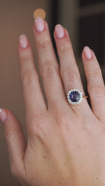 A video of the sapphire and diamond engagement ring worn on a hand, capturing the contrast between the vivid blue centre and bright white diamonds.