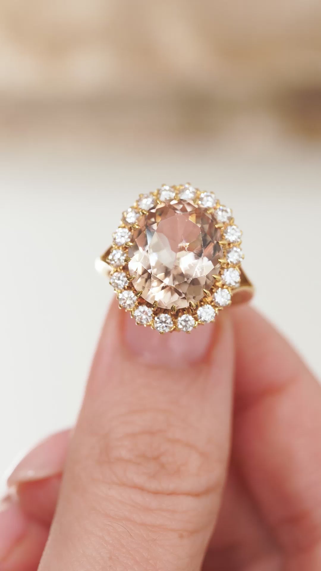 Video presenting the topaz and diamond ring balanced on a fingertip for a detailed view of its oval cluster design.