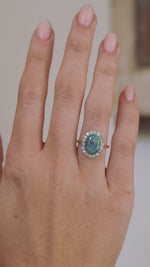 Video showcasing the Edwardian black opal and diamond ring on the hand as the gemstone’s colours shift in the light.