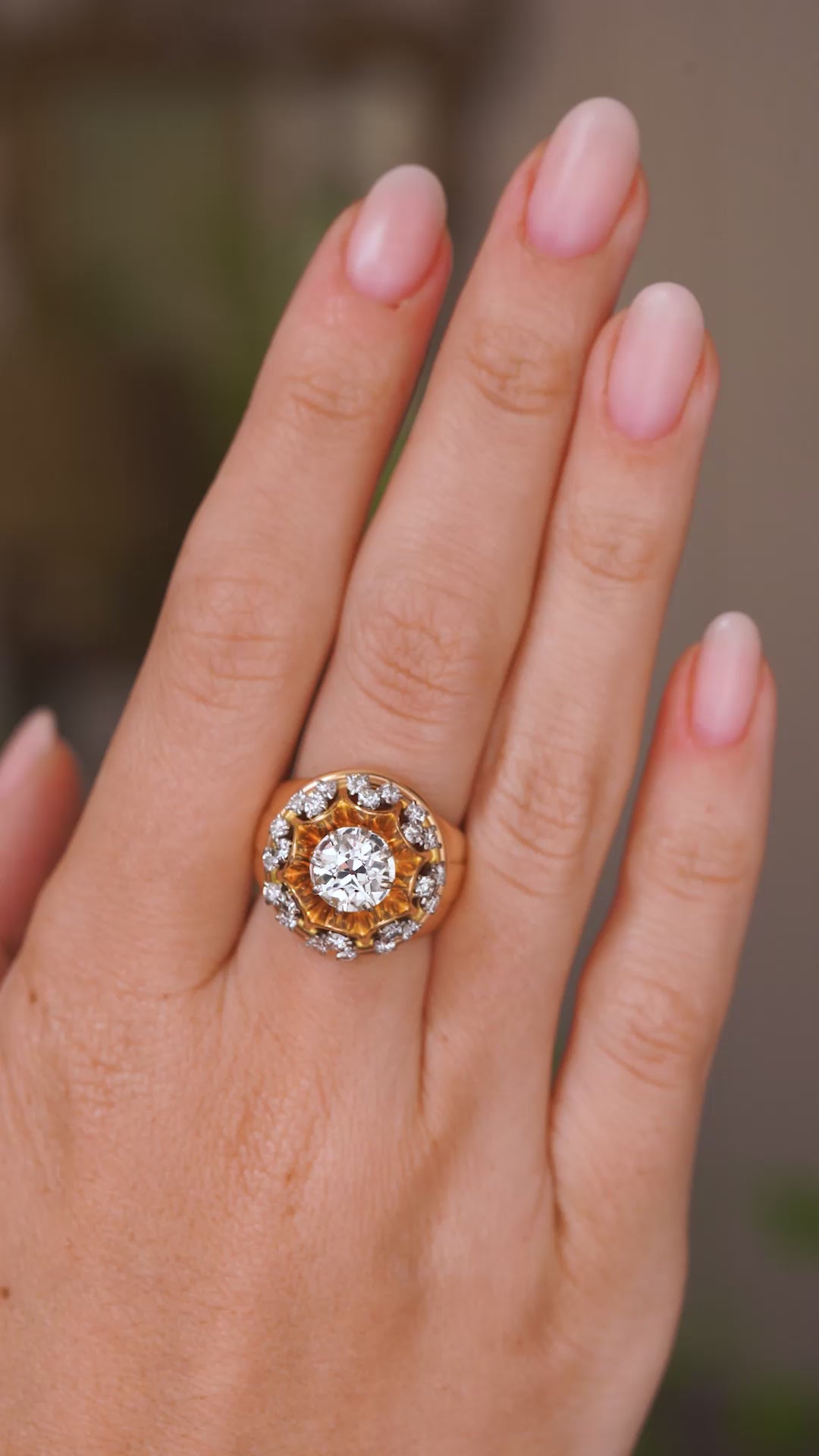 Video of a Vintage old cut diamond cocktail ring from the 1960s.  Worn on a hand and rotated slowly to show the profile and yellow gold band of the setting and ring once worn. 