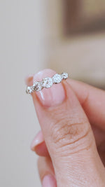 Video close-up of the Edwardian diamond ring balanced on a fingertip, highlighting its graduated proportions and platinum claws.