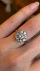 Vintage 1980s diamond cluster ring worn on the left ring finger, showing scale and finger coverage.