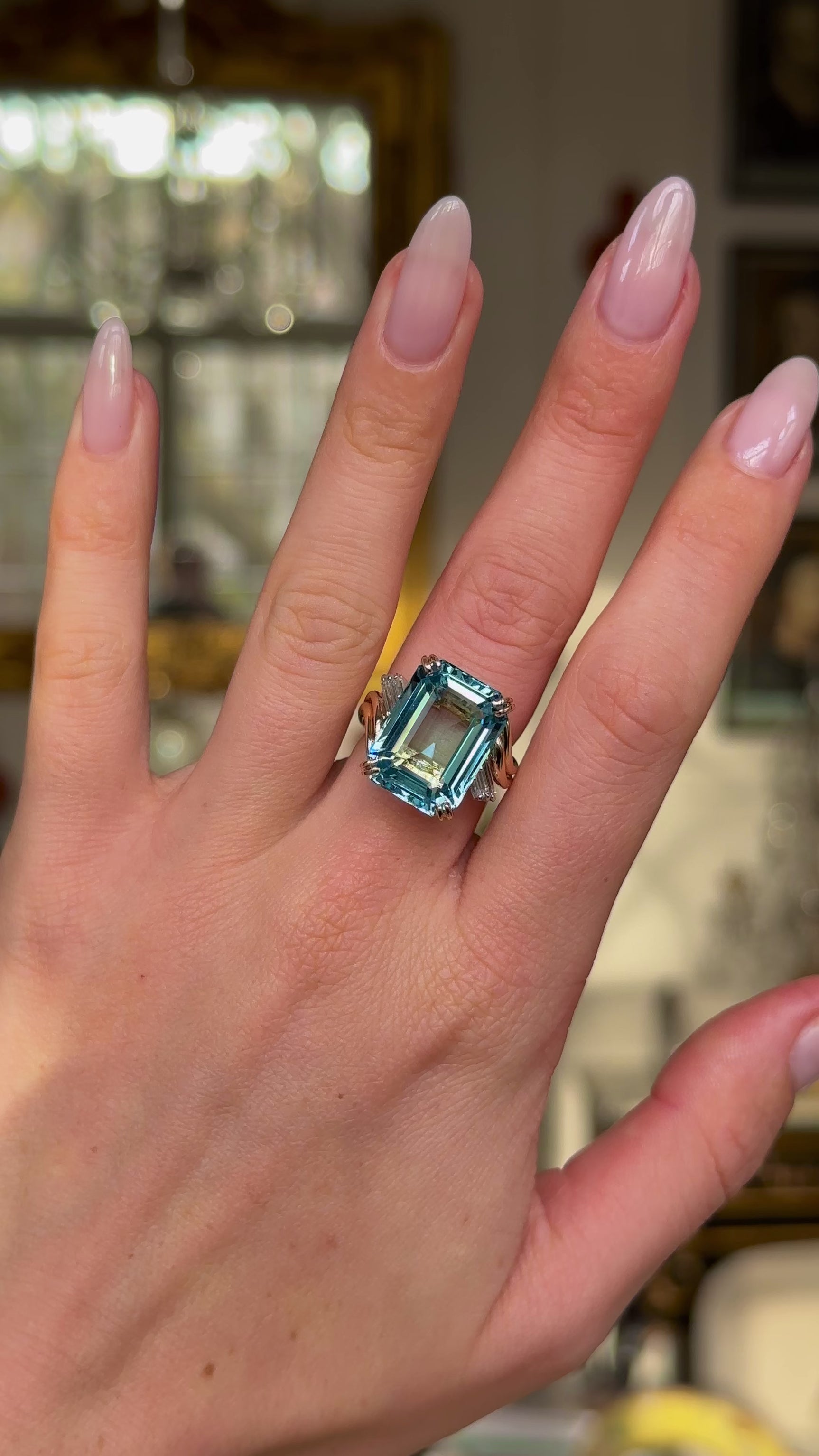 vintage aquamarine and diamond ring worn on hand and moved around to give perspective.
