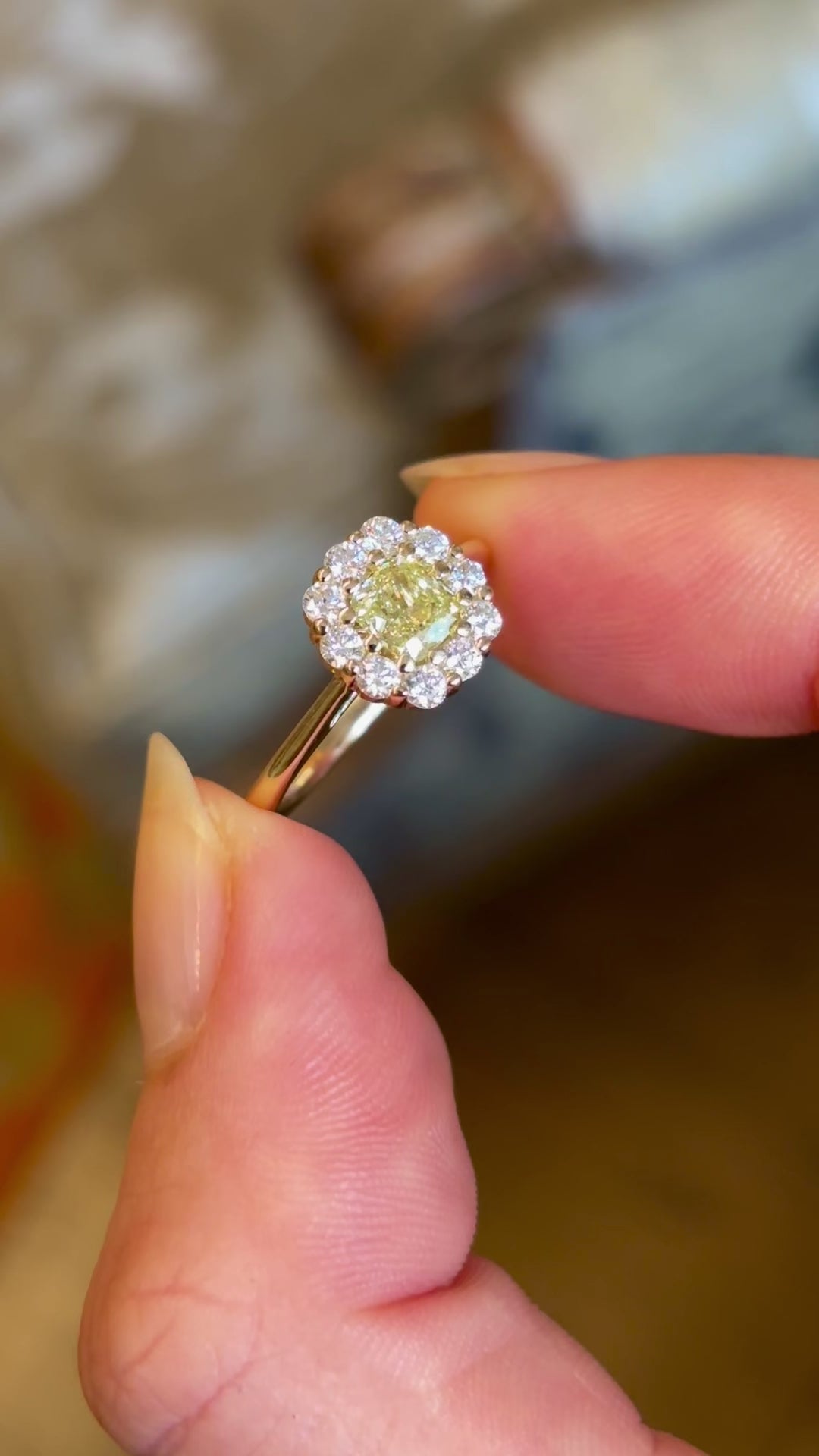 Fancy yellow cushion-cut diamond cluster engagement ring in yellow gold.