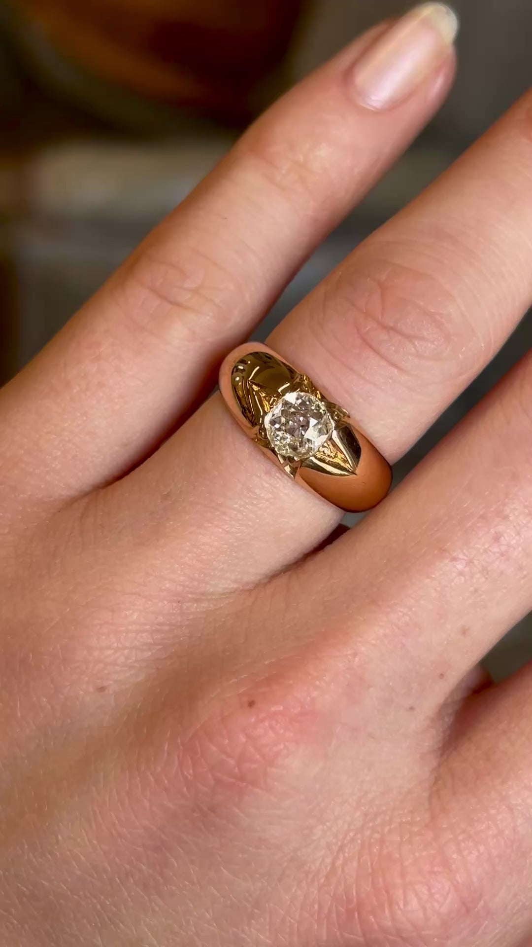 Antique, Victorian diamond solitaire gypsy ring worn on ring finger of left hand and slowly moved back to show entire hand. 