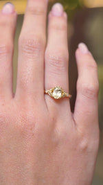 A video of an oval-cut yellow sapphire and diamond engagement ring displayed on the hand in a yellow gold setting.