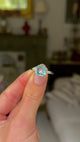 vintage aquamarine and diamond ring held in fingers and moved around to give perspective.