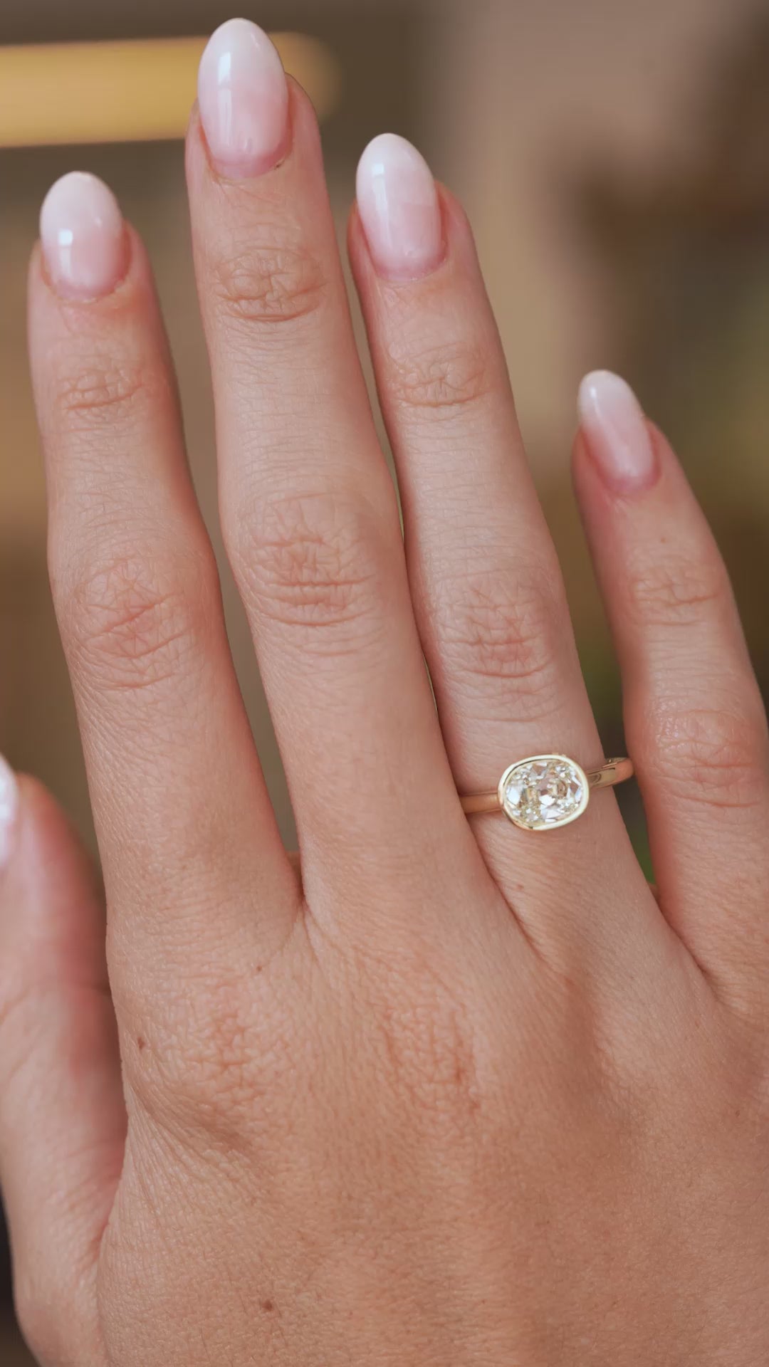Video of an antique-inspired old-mine cut diamond engagement ring worn on the hand, highlighting its sparkle and elegant proportions.