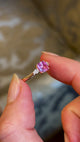 Pink sapphire and diamond three-stone engagement ring