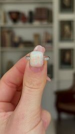 Vintage, Art Deco Cabochon Opal and Diamond Ring, Platinum held in fingers and rotated.
