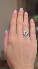 Vintage orange-pink sapphire and diamond cluster ring worn on the hand shown in video in a subtle motion.
