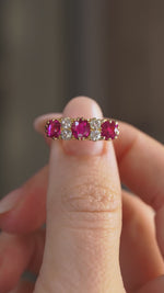 Video presenting the Edwardian ruby and diamond engagement ring balanced on a fingertip as the gemstones catch the light.