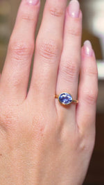 A video of an antique-inspired blue sapphire solitaire engagement ring in yellow gold worn on the hand.
