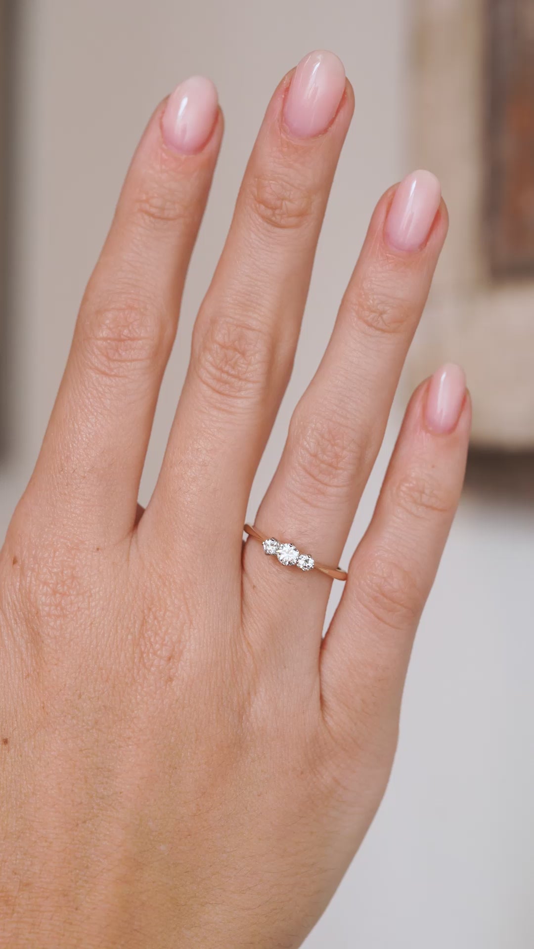 Video of the Edwardian diamond trilogy ring on the hand, capturing the sparkle of all three stones.
