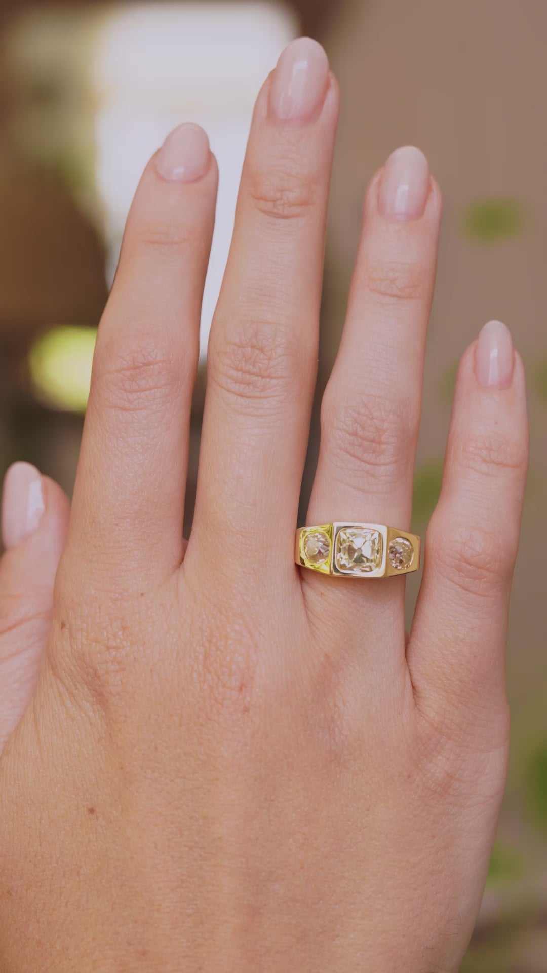 A video of Vintage, 1970s Peruzzi cut diamond three-stone gypsy ring worn on the big hand