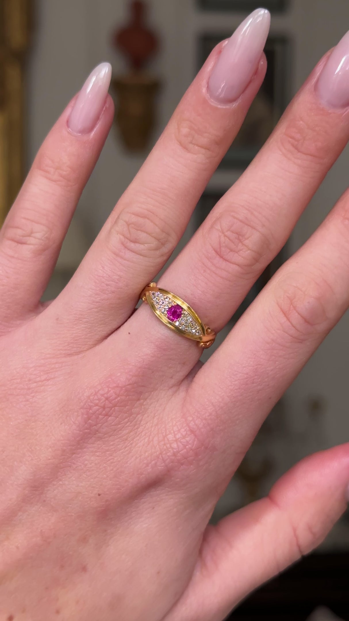edwardian ruby and diamond 18ct yellow gold band on hand, and moved away from lens to give perspective.