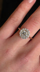 Diamond cluster yellow gold engagement ring on hand in video showing brilliance and scale. 