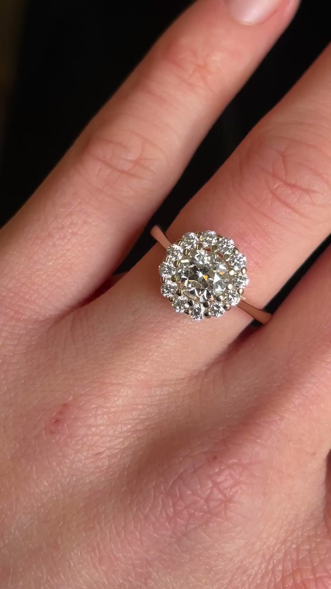 Diamond cluster yellow gold engagement ring on hand in video showing brilliance and scale. 