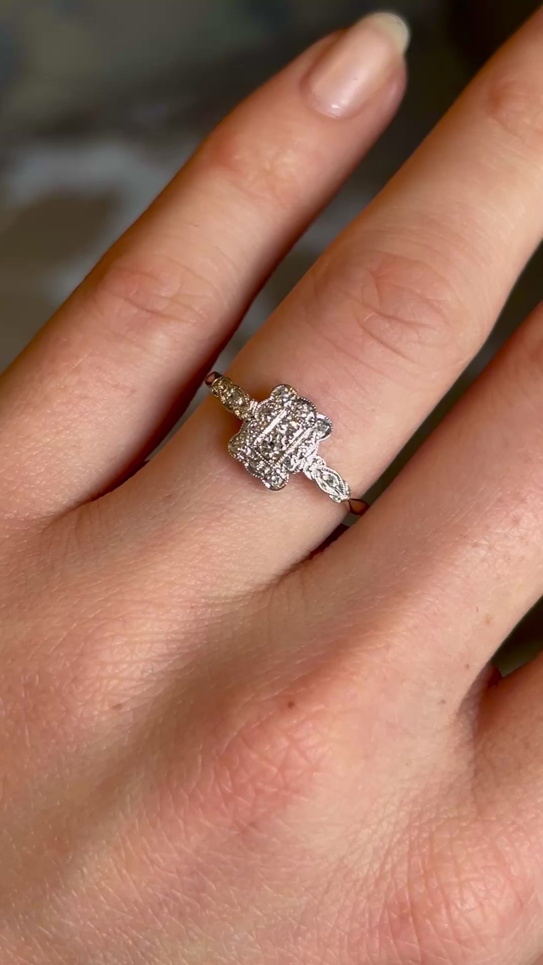 Antique, Edwardian diamond panel cluster engagement ring worn on hand and moved to show details 