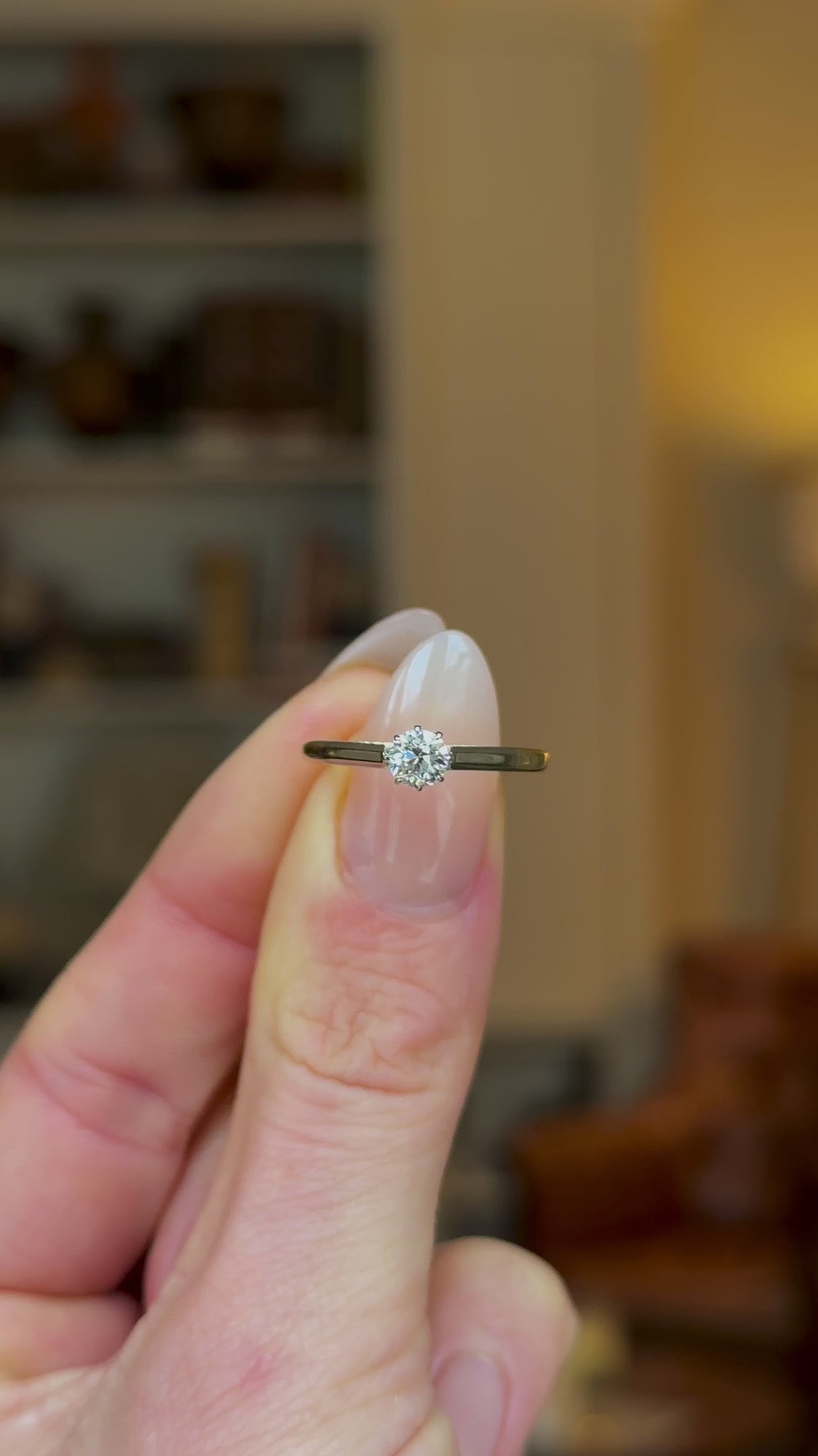 Antique, Edwardian Solitaire Diamond Engagement Ring, 18ct Yellow Gold and Platinum held in fingers and rotated to give perspective.