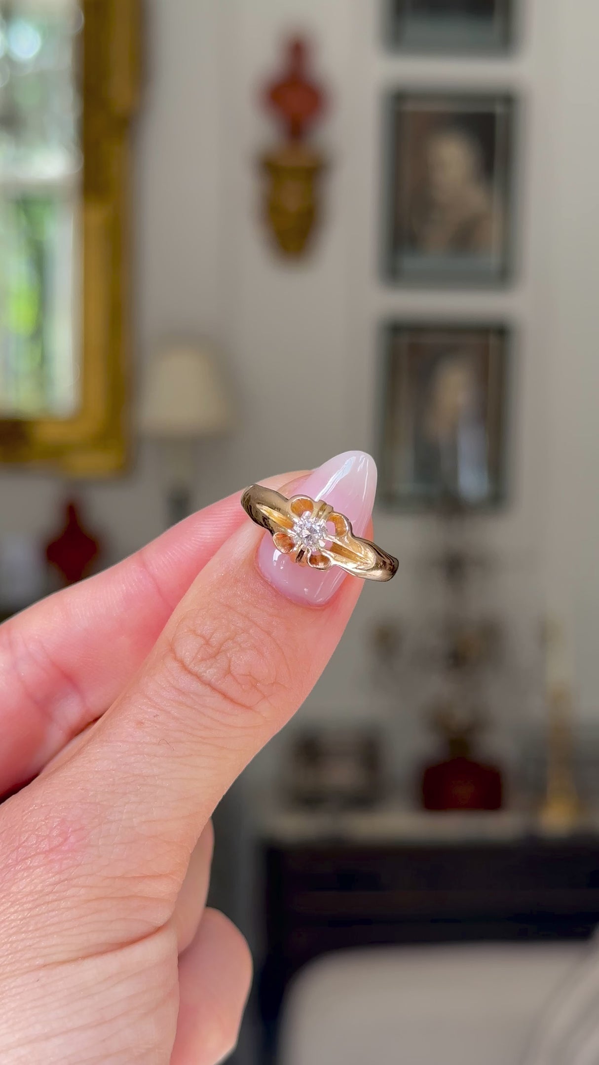 solitaire diamond engagement ring held in fingers and moved around to give perspective.