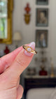 solitaire diamond engagement ring held in fingers and moved around to give perspective.