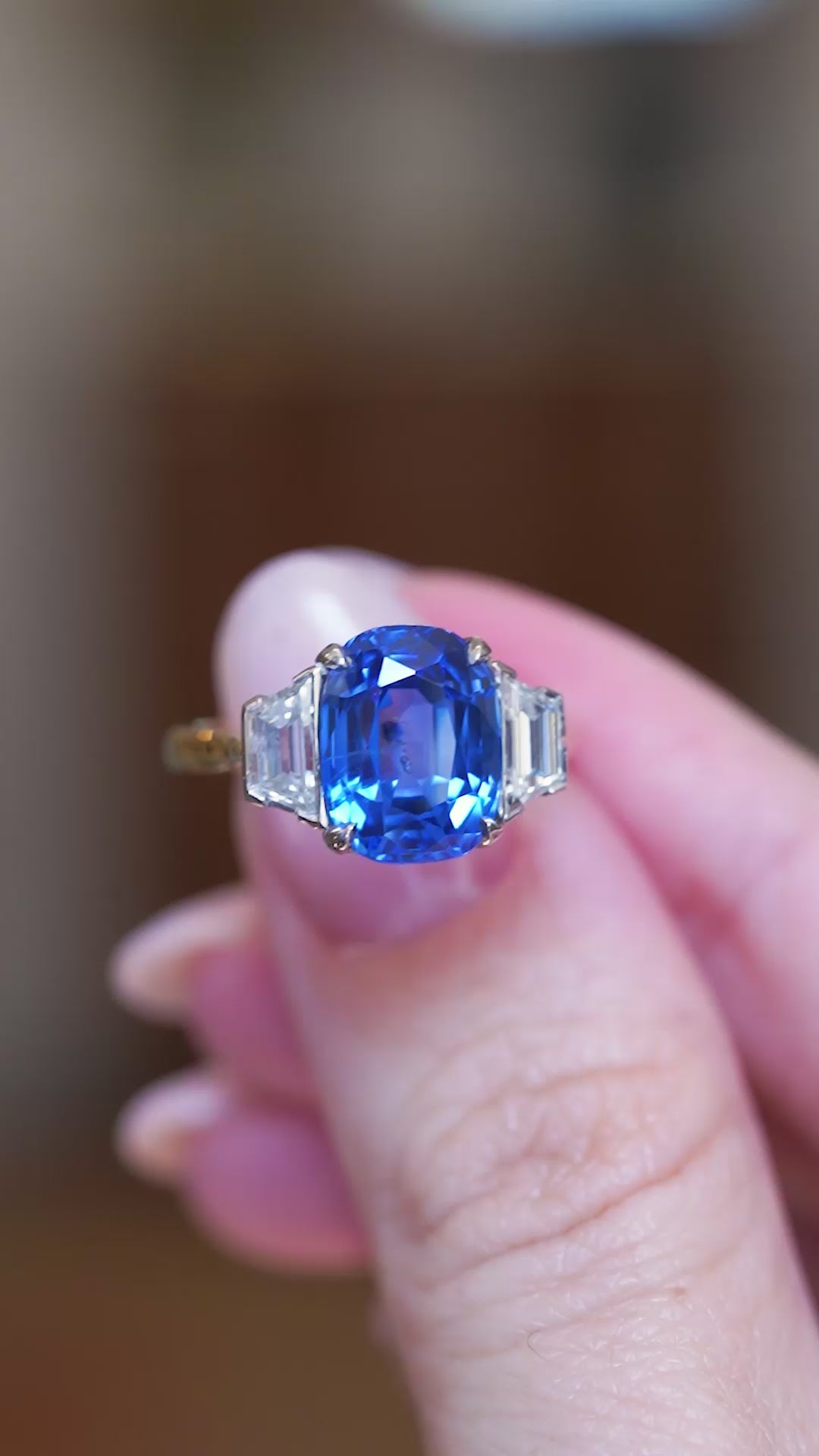 Vintage 1990s sapphire and diamond three-stone ring video highlighting blue sapphire centre stone and tapered diamond side stones.