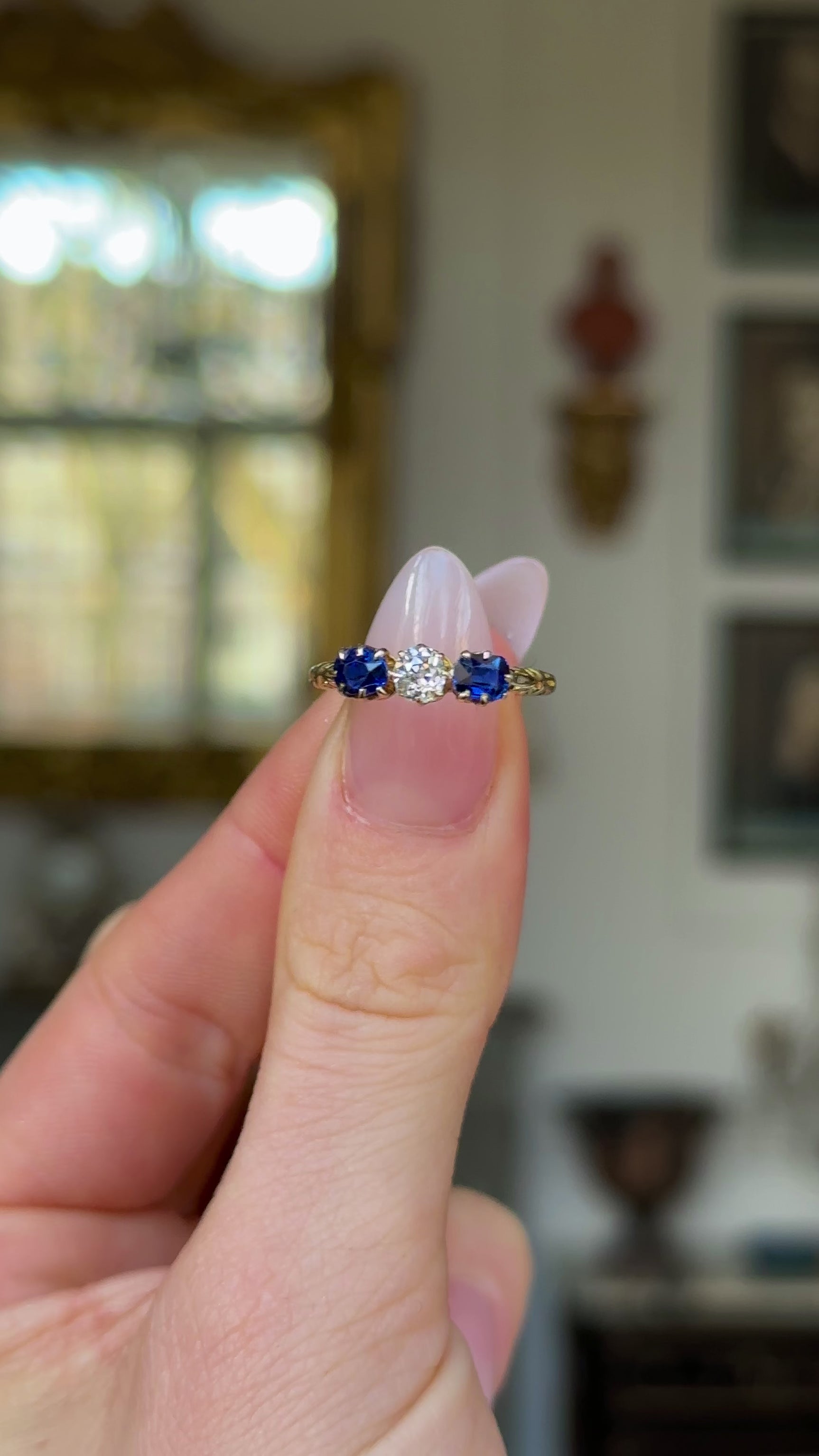 Antique, Edwardian Diamond and Sapphire Engagement Ring, 18ct Yellow Gold held in fingers and rotated to give perspective.