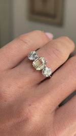 Vintage 1970s yellow sapphire and old-cut diamond three-stone engagement ring featuring a yellow sapphire centre stone flanked by old-cut diamonds, displayed on a hand.