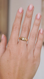 Video of the Victorian diamond solitaire ring on the hand, capturing the polished gold and antique stone’s sparkle.