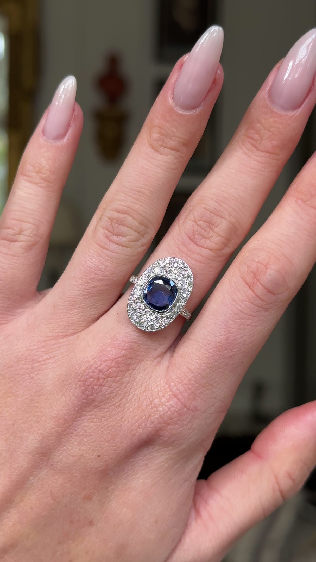 Edwardian sapphire and diamond ring, worn on hand and rotated to give perspective.