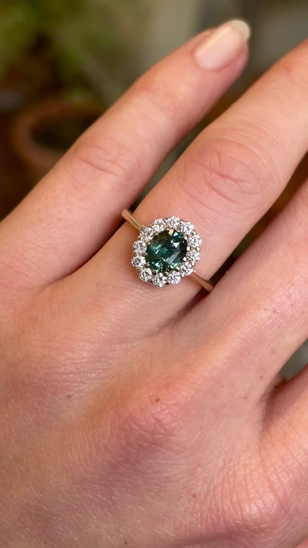 Green sapphire and diamond cluster engagement ring