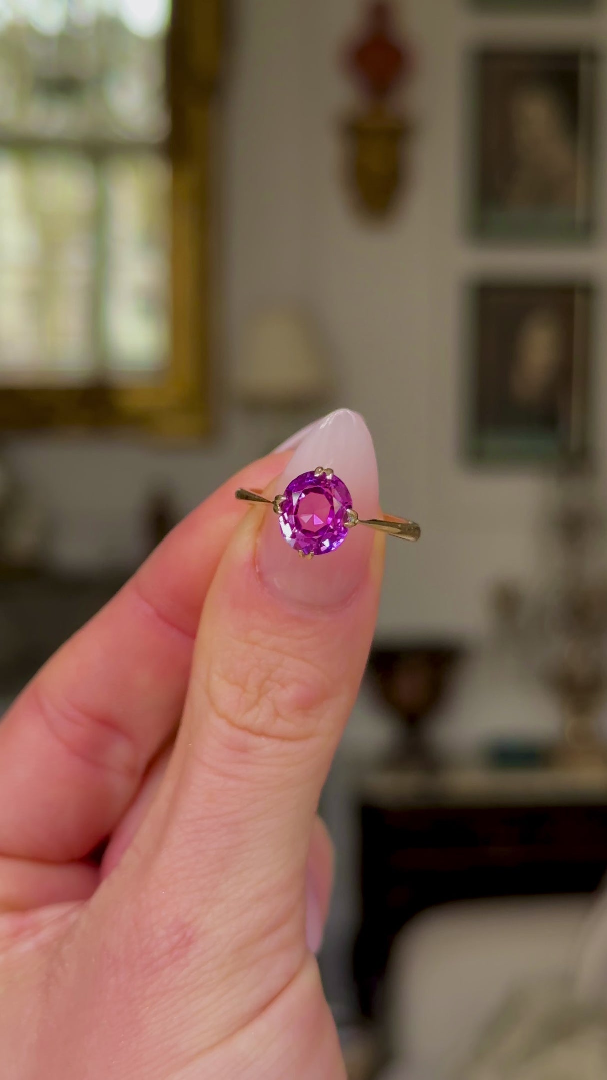 Vintage, 1940s Pink Sapphire Single-Stone Ring, held in fingers and rotated to give perspective.