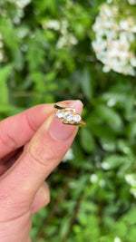 Vintage, 1967 Three-Stone White Sapphire Engagement Ring, 18ct Yellow Gold held in fingers.