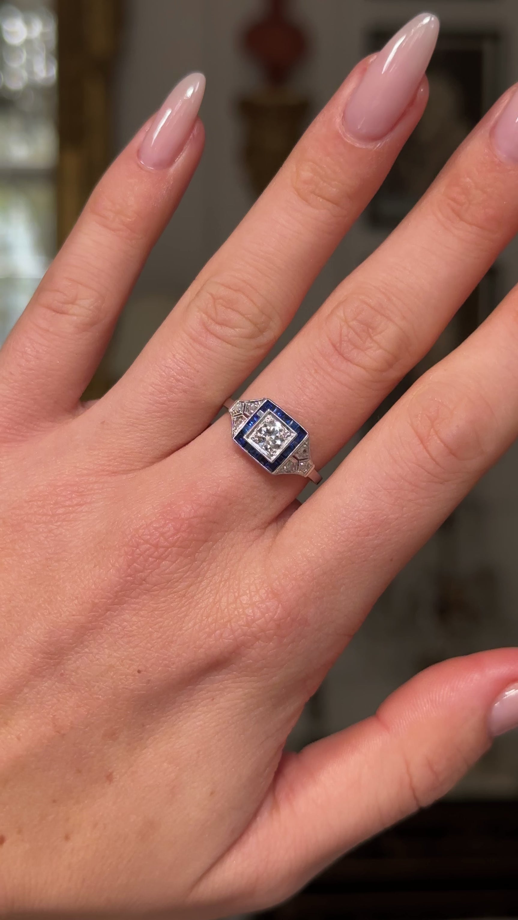 Vintage sapphire and diamond engagement ring, worn on hand and moved around to give perspective.