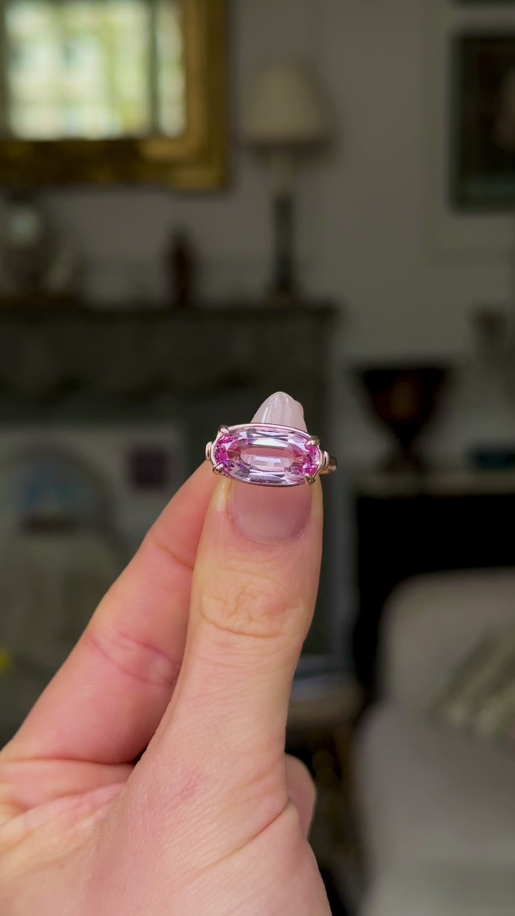 Vintage, 1940s Pale Pink Topaz Ring held in fingers and rotated to give perspective.