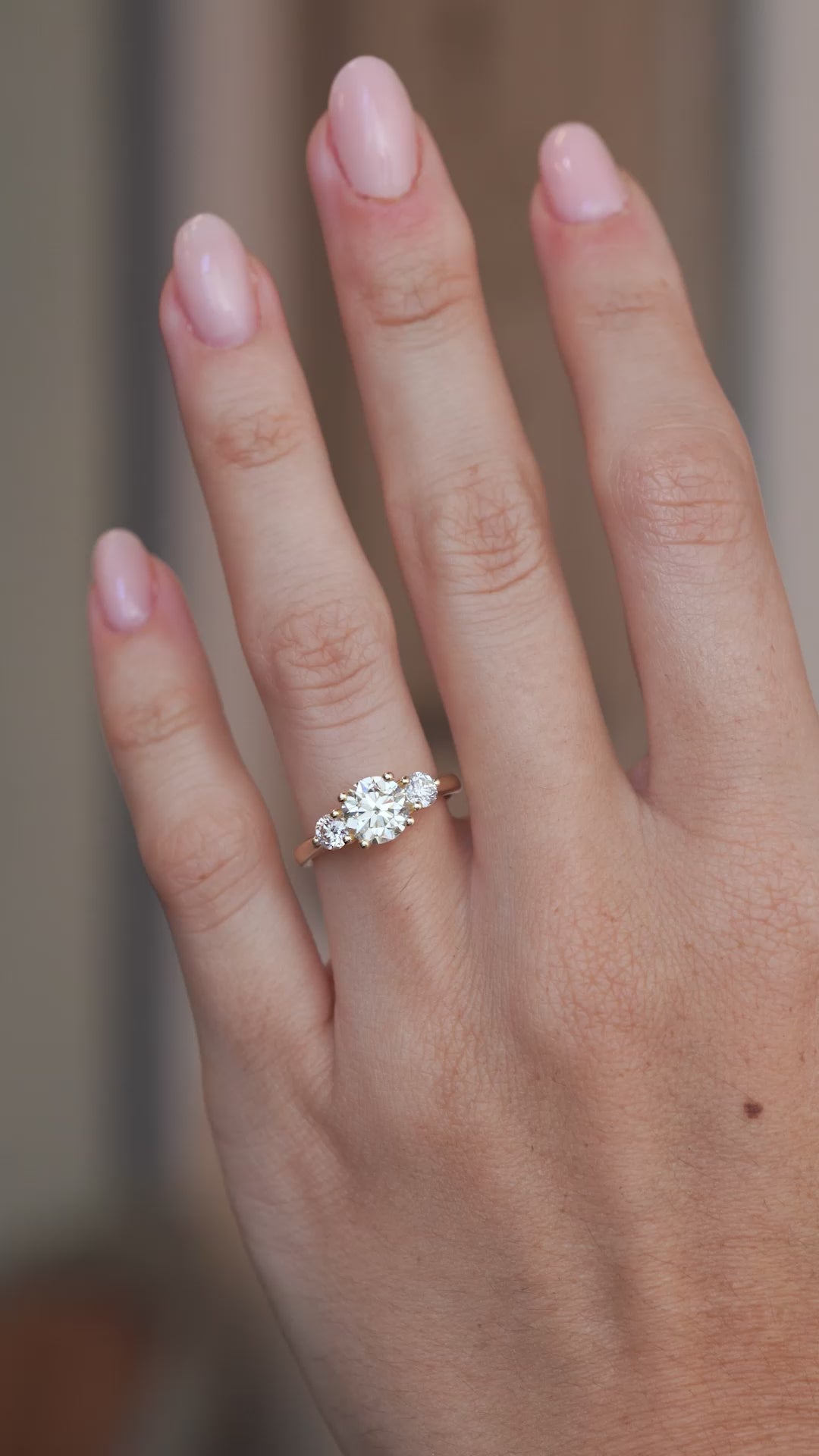 Video of an oval pale yellow diamond engagement ring worn on a finger, capturing its sparkle and delicate design.