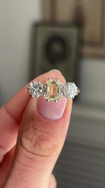 Vintage 1970s yellow sapphire and old-cut diamond three-stone engagement ring showcasing a yellow sapphire centre stone with old-cut diamond side stones, held by hand to highlight the setting and craftsmanship.